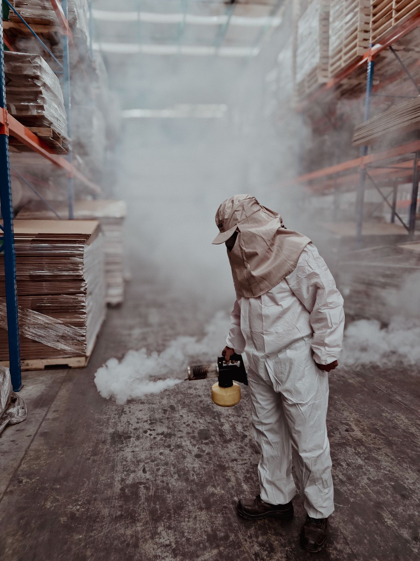 Technician fumigating a warehouse
